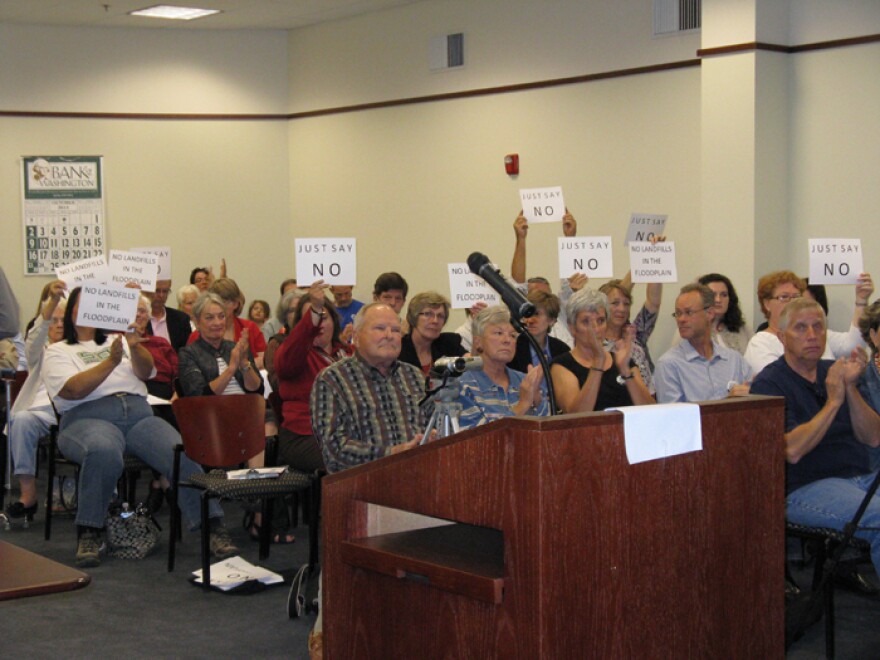 Franklin County residents hold up signs to show their opposition to Ameren's landfill plans at a meeting of the county commission in 2011, just before the commission voted to change its zoning regulations to allow coal ash landfills.