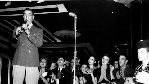 Bandleader Benny Goodman performs with his orchestra while playing the clarinet at Roseland Ballroom in New York City in 1938. (AP Photo)