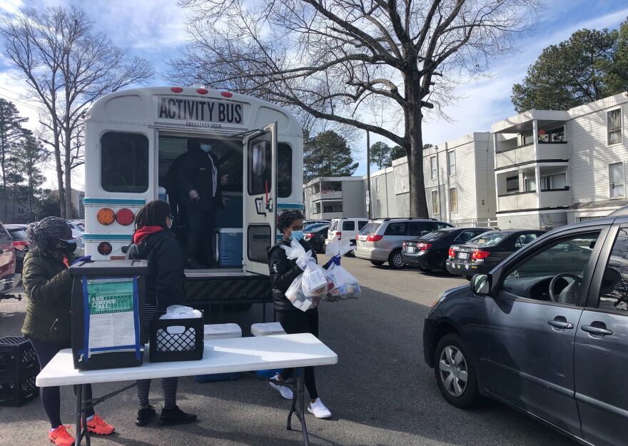 WCPSS bus drivers and nutritionists help distribute meals at Cedar Point Apartments in Raleigh.