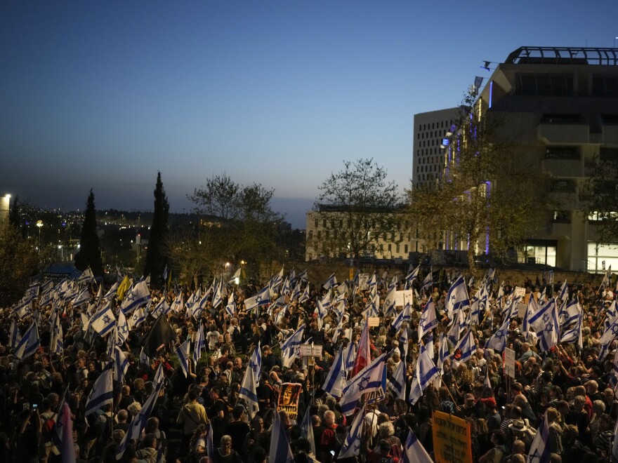 People take part in a protest against Israeli Prime Minister Benjamin Netanyahu's government and call for the release of hostages held in the Gaza Strip by the Hamas militant group outside of the Knesset, Israel's parliament, in Jerusalem, Sunday, March 31, 2024.