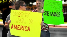 Ginny Sain, left and Anna Marie Lane protest the conditions at the Oklahoma County Jail Tuesday evening.