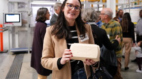 A Tanbark-manufactured container is held by Meaghan Dillon, VP of Marketing for Luke's Lobster, during the Tanbark's launch event on Oct. 11, 2023.