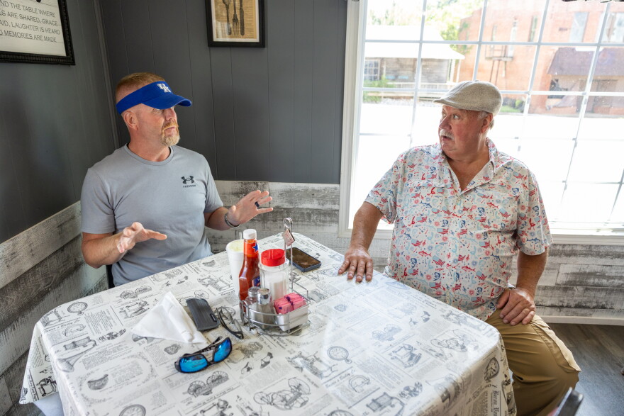 Mark Geary, a customer at Papaw's Poole Mill Restaurant, chats with owner Kenneth Todd about their experiences with alpha-gal syndrome.