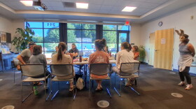 A group of actors rehearses an argumentative dinner scene at the Mancos Public Library ahead of the Golden Fox Paradox.