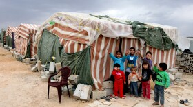 Syrian children flash victory signs Oct. 2 as they stand in front of their tents at a refugee camp in Arsal, a Sunni Muslim town in eastern Lebanon near the Syrian border. The town has become a safe haven for war-weary Syrian rebels.