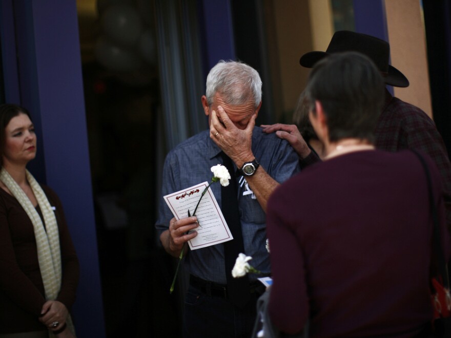 Ross Zimmerman, father of Gabe Zimmerman, mourns at his son's memorial service in Tucson, Arizona Jan. 17.