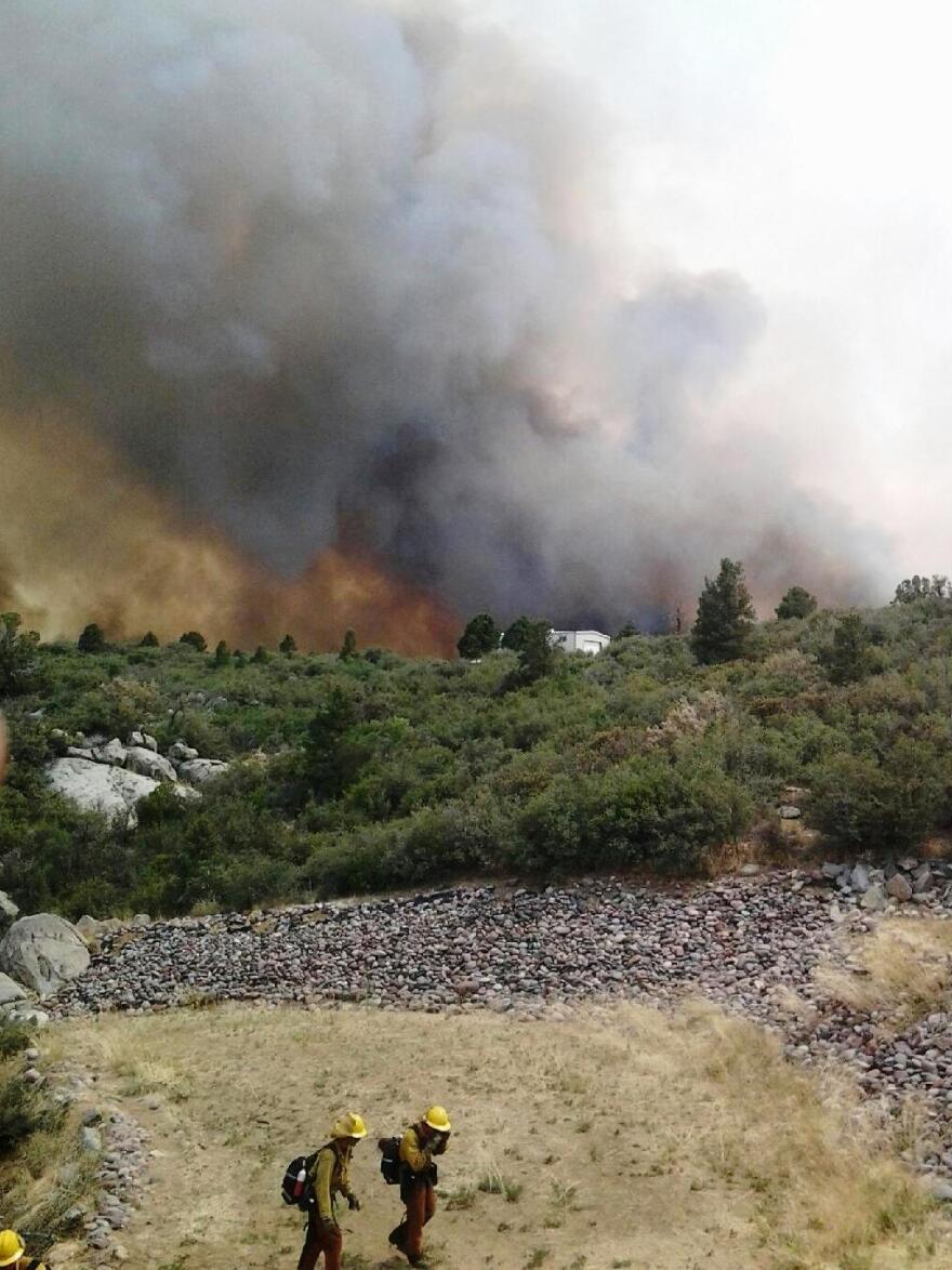Firefighters are seen working on the Yarnell Hill fire, in this photograph from this weekend provided by the Arizona State Forestry Division. Officials say 19 firefighters died battling the blaze Sunday.