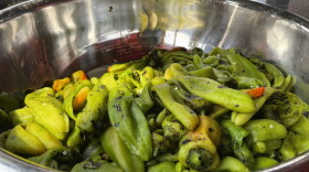 FILE - This July 12, 2021 image shows a large bowl of roasted green chile at a market in Hatch, N.M. (AP Photo/Susan Montoya Bryan, File)