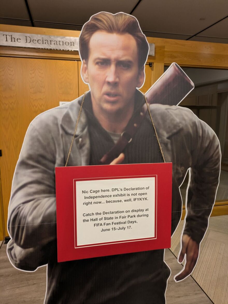 A cardboard cutout of actor Nicholas Cage from his movie National Treasure is now on display in the Dallas Central Library to let residents know the copy of the Declaration of Independence is temporarily on display in the Hall of State at Fair Park.