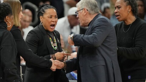 South Carolina head coach Dawn Staley and UConn head coach Geno Auriemma talk during the first half of a woman's NCAA college basketball tournament semifinal game at the Final Four, Friday, April 3, 2026, in Phoenix. (AP Photo/Rick Scuteri)
