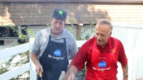 Republican Rep. Steve King of Iowa (right) flips pork chops at the Iowa State Fair in Des Moines while Terry Aupperle of Wiota watches. Aupperle lives in Cass County. He can't vote for King anymore because of redistricting.