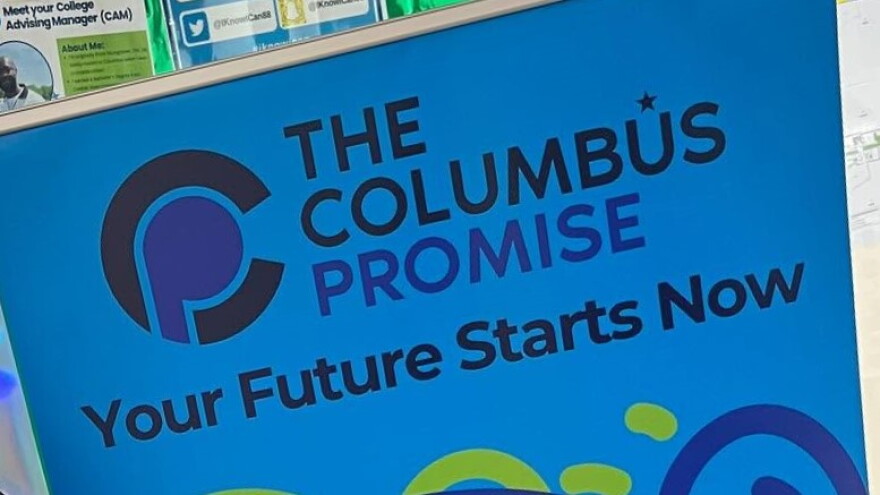 A sign reads "The Columbus Promise. Your Future Starts Now." 