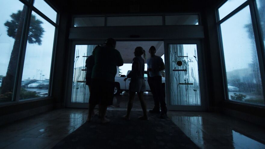 Corpus Christi, Texas, residents watch the Hurricane Harvey in the dark after a citywide power failure Friday.