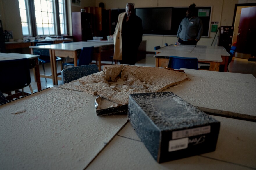 St. Louis Public Schools communications staffers walk through a tornado damaged art classroom at Sumner High School on Wednesday, Nov. 5, 2025, in north St. Louis.