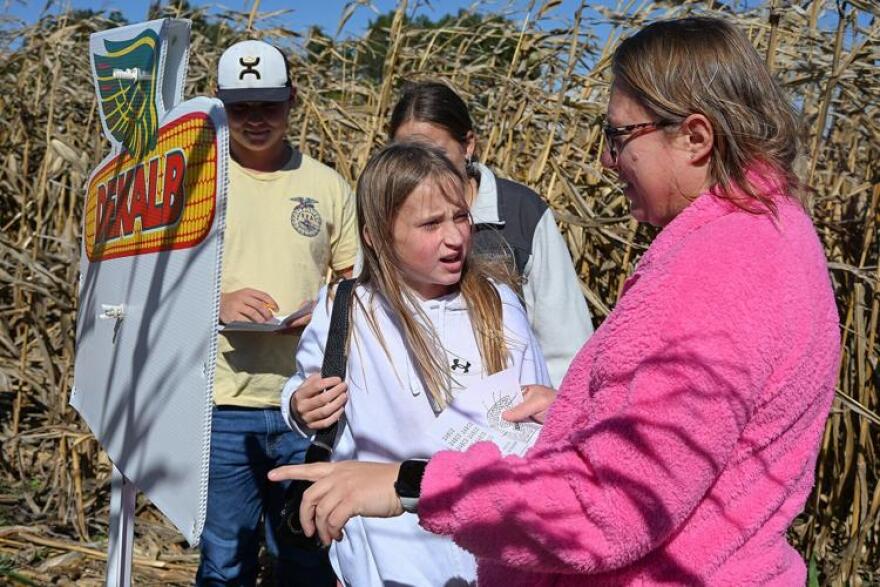 From left, Sam Truesdell, 15, Lizzie Truesdell, 10, Adrianna Stemme, 16, and Jennifer Truesdell discuss a corn trivia question last weekend at Boots Farms in Moberly. The questions were placed throughout the corn maze to help guide visitors. Corn mazes such as those in central Missouri are part of a larger trend in agritourism.