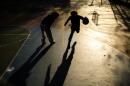 Young boys play basketball on a playground in the Hamilton Heights neighborhood of Manhattan in New York City on November 19, 2025. (Charly Triballeau/AFP via Getty Images)