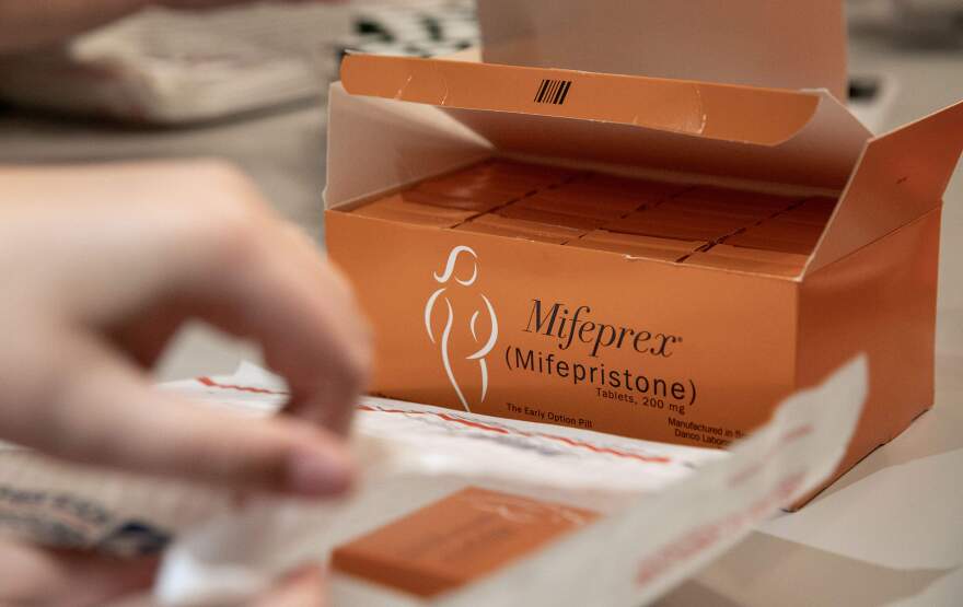 Massachusetts Medication Abortion Access Project volunteers pack envelopes with medication and information. (Robin Lubbock/WBUR)