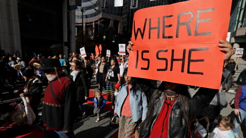 FILE - Dennis Willard, of Bellevue, Wash., carries a sign that reads "Where Is She" as he marches in support of missing and murdered indigenous women during a rally to mark Indigenous Peoples' Day in downtown Seattle, on Oct. 14, 2019. (AP Photo/Ted S. Warren, File)