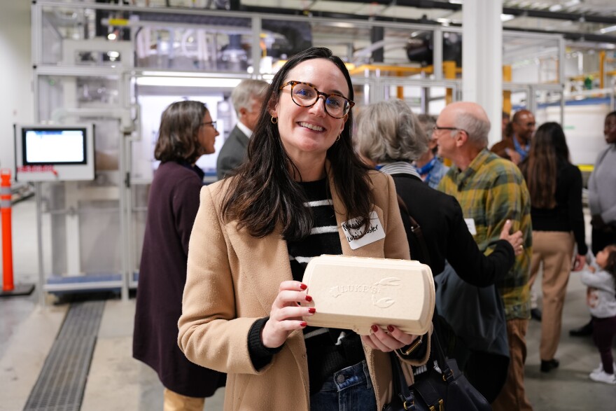 A Tanbark-manufactured container is held by Meaghan Dillon, VP of Marketing for Luke's Lobster, during the Tanbark's launch event on Oct. 11, 2023.