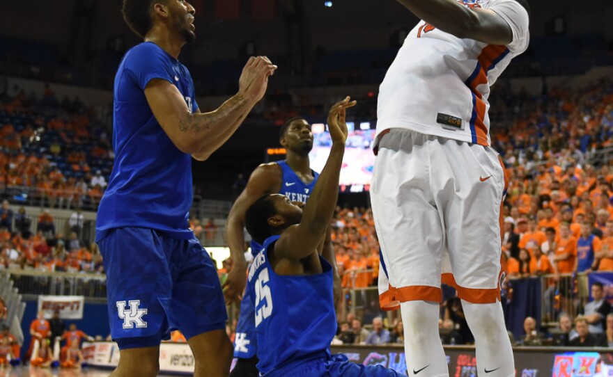 While going up for a layup in the second half, Florida's Dorian Finney-Smith (10) is fouled by Kentucky’s Dominique Hawkins (25). In his final home game as a member of the Gators, Finney-Smith scored 15 points while also dishing out 5 assists and grabbing 5 rebounds. (Greenberry Taylor/WUFT News)