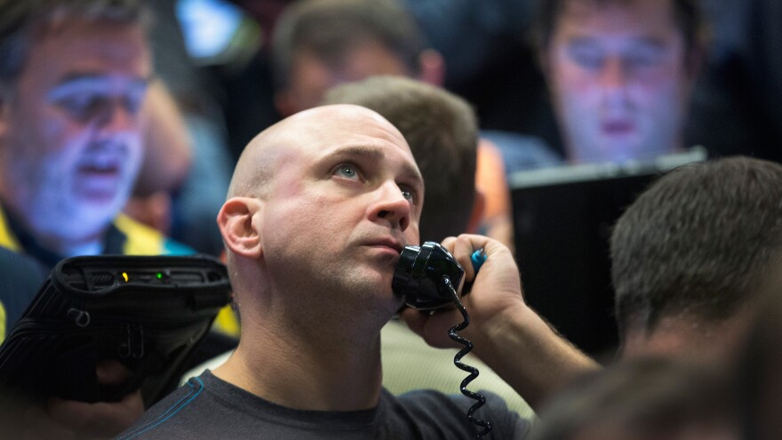 A trader fills orders Monday in the Standard & Poor's 500 stock index options pit at the Chicago Board Options Exchange. Watching market numbers plummet can make investors queasy, but analysts say keeping a level head through volatility is the best course.