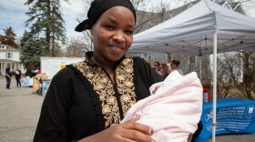 Musamiyamana Firdous, originally from Burundi, arrived in the U.S. last year. She holds her baby girl Ayra but is also due to give birth in six weeks. She went to the baby shower hoping to find a way to afford diapers and wipes. A leader in her community told her about the event.