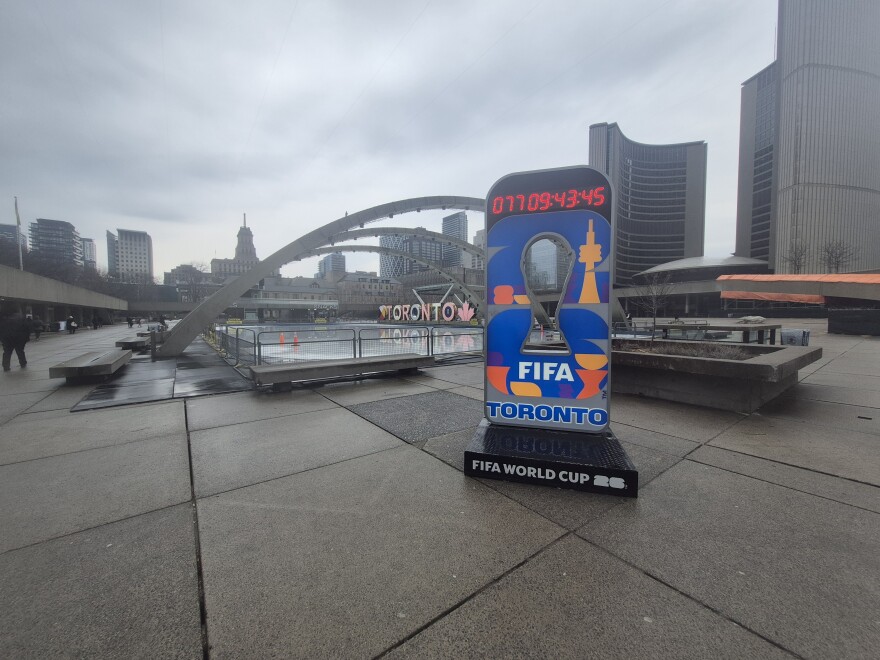 FIFA 2026 countdown clock outside of Toronto's City Hall. Large landmark Toronto sign behind it. 