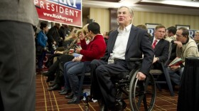 Texas Attorney General Greg Abbott greets members of the Texas "strike force" in Iowa to support Governor Rick Perry on January 3, 2012.