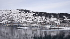 A snow-covered boat travels past Kodiak’s harbor. (Photo by Kavitha George/KMXT)