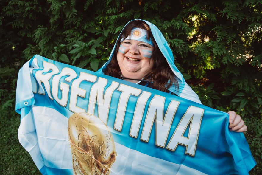 Tina Lanius, of St. Louis' Shaw neighborhood, shows off her Argentina swag ahead of the FIFA World Cup at Tower Grove Park on Tuesday in south St. Louis. "It's still a pinch-me moment," she said. "I cannot believe one week from today I'm going to be watching Argentina live in a World Cup."
