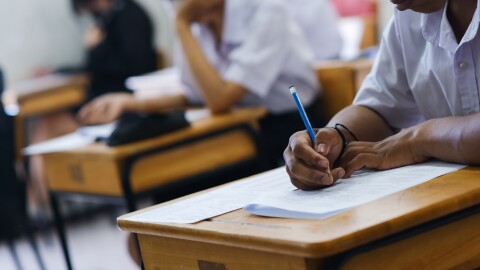 Assessment examination of high school students dressed in uniform.