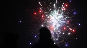 Alexander Burnor and his fiance Anita Monroe look on as Kotzebue celebrates the new year with fireworks on Jan. 1, 2020. 