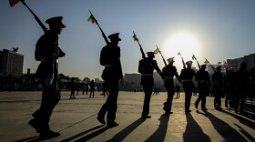 Ethiopian military parade with national flags attached to their rifles at a rally organized by local authorities to show support for the Ethiopian National Defense Force (ENDF) in downtown Addis Ababa, Ethiopia, on Nov. 7, 2021. (AP)
