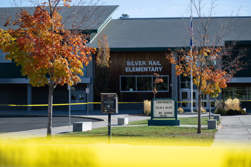 Police caution tape surrounds Silver Rail Elementary in Bend, Ore., Friday, Oct. 16, 2026, a day after a deadly shooting.