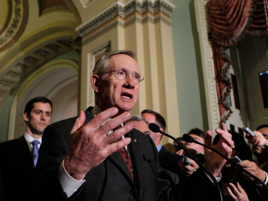 Senate Majority Leader Harry Reid speaks with reporters Tuesday after the Senate cleared a hurdle to restore unemployment benefits to millions of Americans who have been out of work for more than six months.