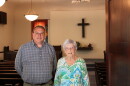 A man and older woman stand next to each other in North Danvers Mennonite Church