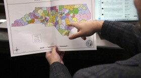 FILE - The North Carolina state House reviews copies of a map proposal for new state House districts during a committee hearing at the Legislative Office Building in Raleigh, N.C., Thursday, Oct. 19, 2023. A judge refused Friday, Jan. 26, 2024, to prevent the use of two North Carolina Senate districts drawn by Republican legislators starting with the 2024 elections and to order them replaced with boundaries that lawsuit plaintiffs argue would more likely ensure Black voters elect preferred candidates in one of them. (AP Photo/Hannah Schoenbaum)