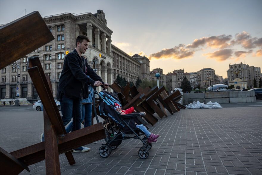 A family walks through a barricade at a nearly deserted Maidan Square on in Kyiv, Ukraine.