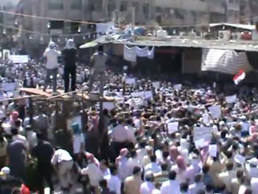 Footage from a YouTube video shows what Syrian activists said was a protest against President Assad's government in the Damascus suburb of Douma on Friday.