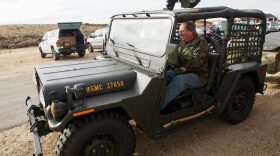 Roy Cagnacci drives his Vietnam-era Ford Mutt mounted with a belt-fed machine gun at the Idaho Automatic Weapons Collectors' Association annual Pumpkin Shoot. The group is part of a subculture of gun owners who collect heavily-regulated machine guns. 