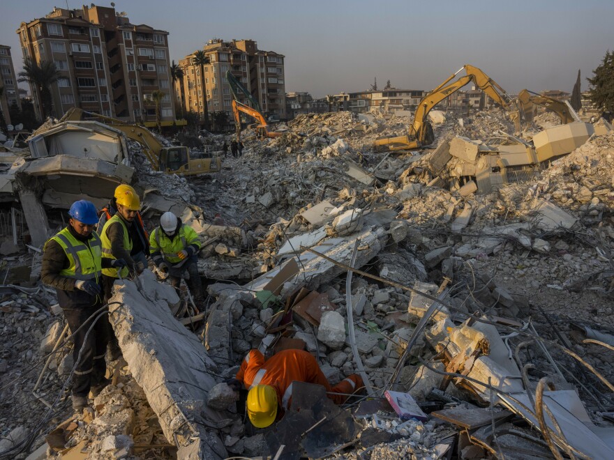 Members of a search and rescue operation work Sunday on an area that collapsed during the earthquake in Antakya, in southeastern Turkey. Disaster recovery experts say ordinary people are crucial to saving lives.