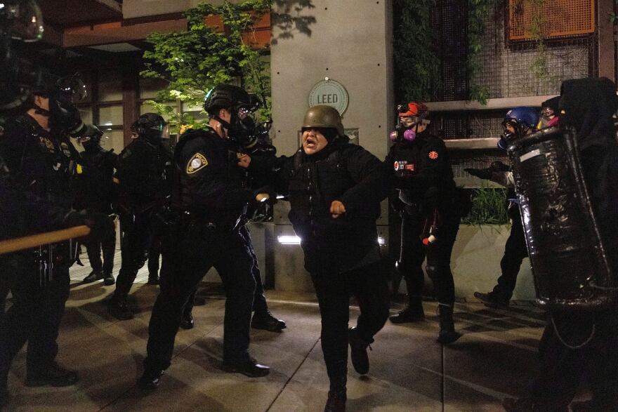 Police confront May Day protesters at the Immigration and Customs Enforcement, ICE, facility on Saturday, May 1, 2021 in Portland, Ore. From Portland to Salem, May Day demonstrators attended protests to make their voices heard.
