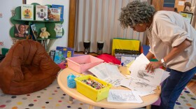 Sharon Collins, gift store manager at The Kansas African American Museum, arranges the children's corner in the Wichita museum.