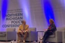 Kyle Melinn, news editor for Michigan Information & Research Service Inc. (MIRS) (left), interviewing Michigan Secretary of State Jocelyn Benson (right), at the Northern Michigan Policy Conference on January 23, 2026 at the Grand Traverse Resort & Spa. (Photo: Vivian La/IPR)