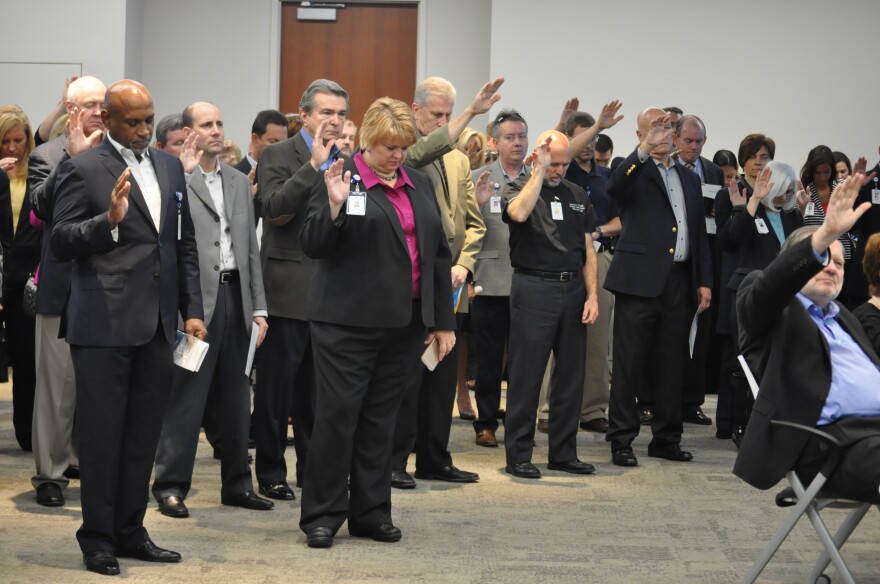 Mercy personnel participate in a benediction held at the new care center on Tuesday.