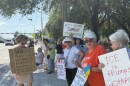 Anti-Trump activists protest Saturday morning, July 26, 2025, near the Boca Raton headquarters of GEO Group, one of the country’s largest private prison contractors, demanding U.S. Immigration and Customs Enforcement (ICE) ends its business ties with companies housing immigrants.