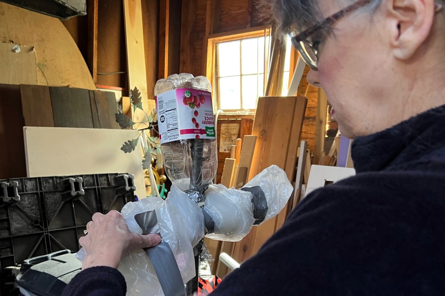 A woman builds scarecrows dressed as witches in her garage.