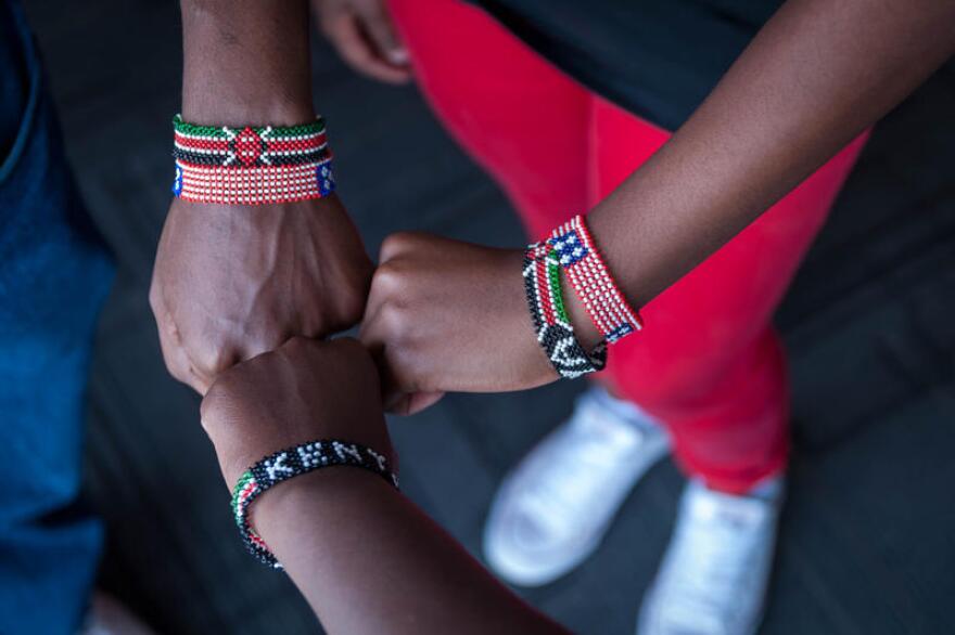 Geoffrey Soyiantet, Sally Gacheru and Gracemary Nganga compare their Kenyan beed bracelets. Several teens from the St. Louis area are now in their home country of Kenya for about two weeks through Soyiantet's Vitendo4Africa organization.