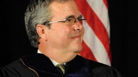 Former Florida Gov. Jeb Bush listens during Ave Maria's commencement ceremony Saturday.