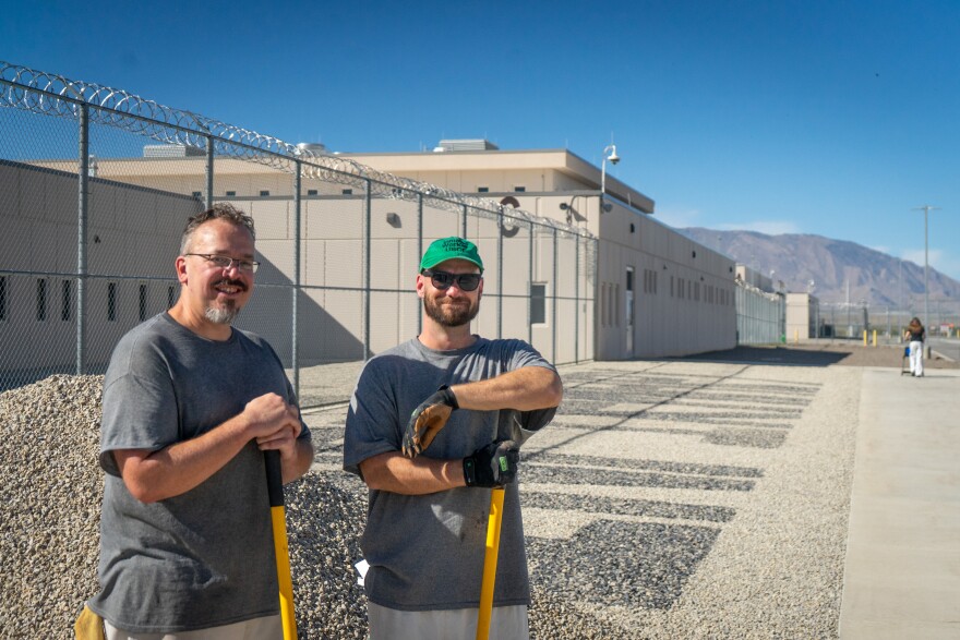 Ryan Parker and Alexander Wardell dig from a gravel pile in the yard of the Utah State Correctional Facility, Aug. 20, 2026. The gravel is for a piece of landscaping art that’s part of a prison work program that replaces grass that’s friendly to mosquito breeding.